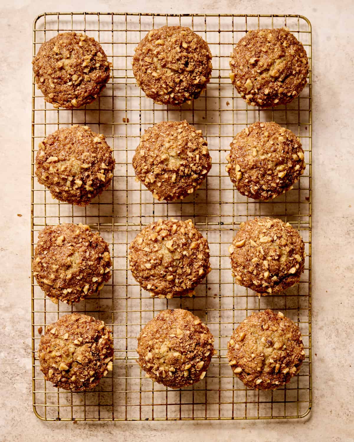 Overhead view of baked banana muffins on a cooling rack.