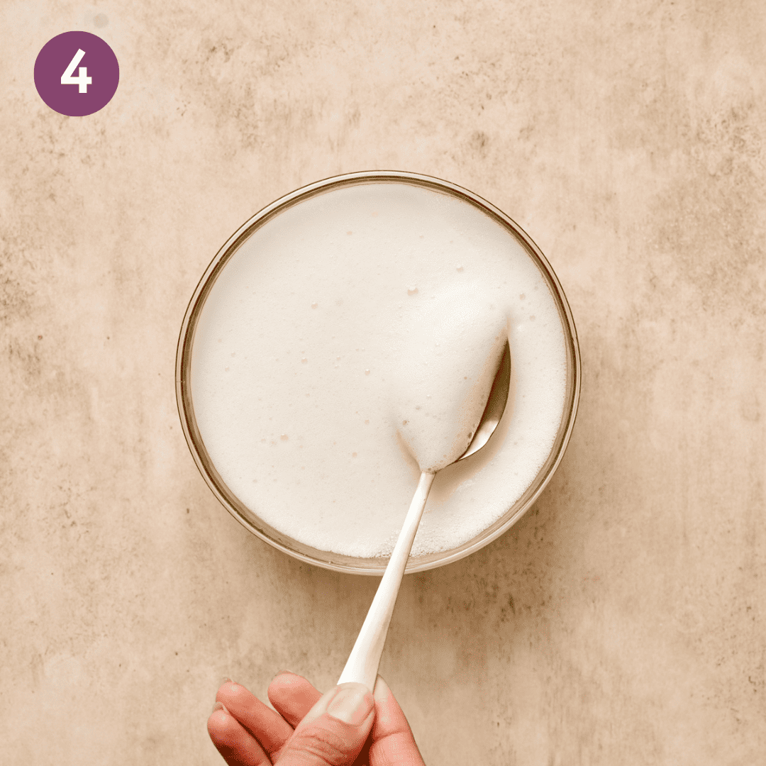 Whipped aquafaba in a small glass bowl.