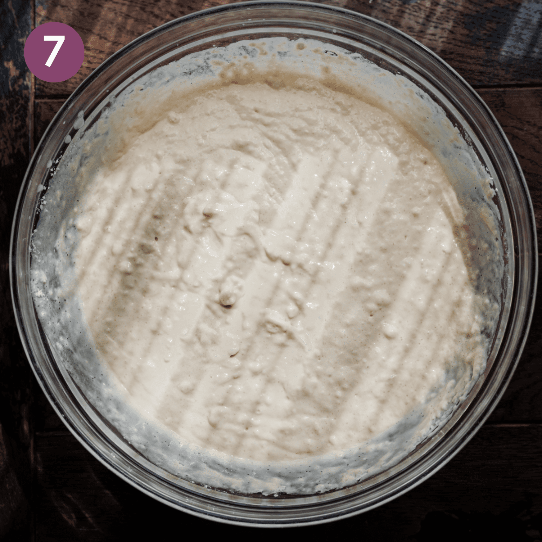thick vegan pancake batter in a glass bowl on a wooden table. 