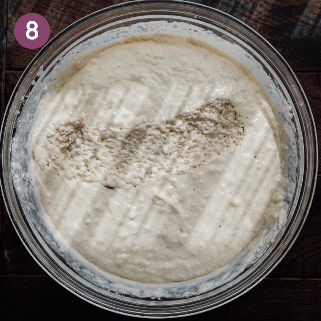 thick vegan pancake batter in a glass bowl with a streak in the middle showing airy texture. 