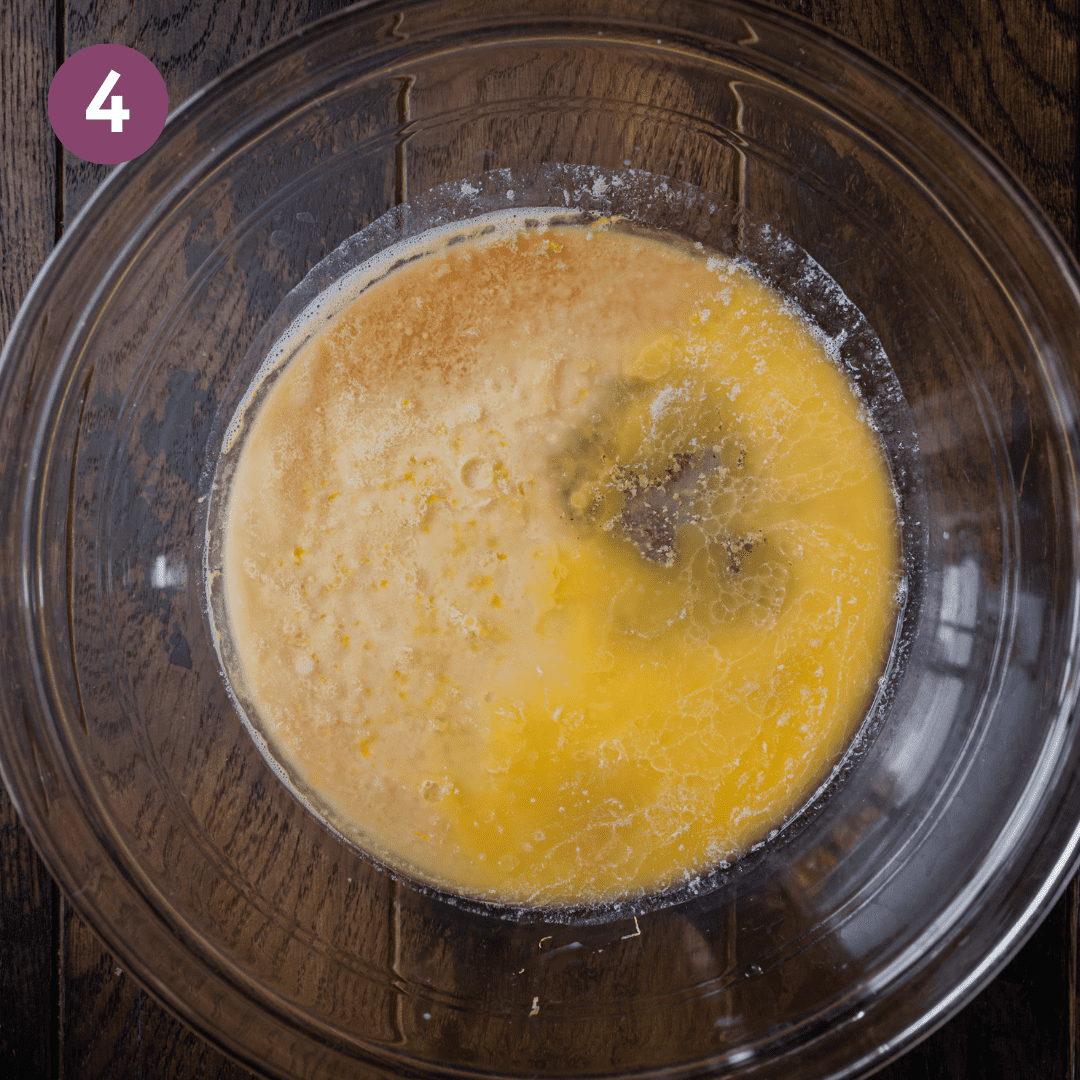 bowl of melted butter and milk on wooden board.