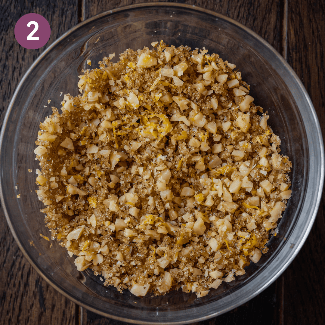brown sugar-walnut topping in bowl on wooden board.