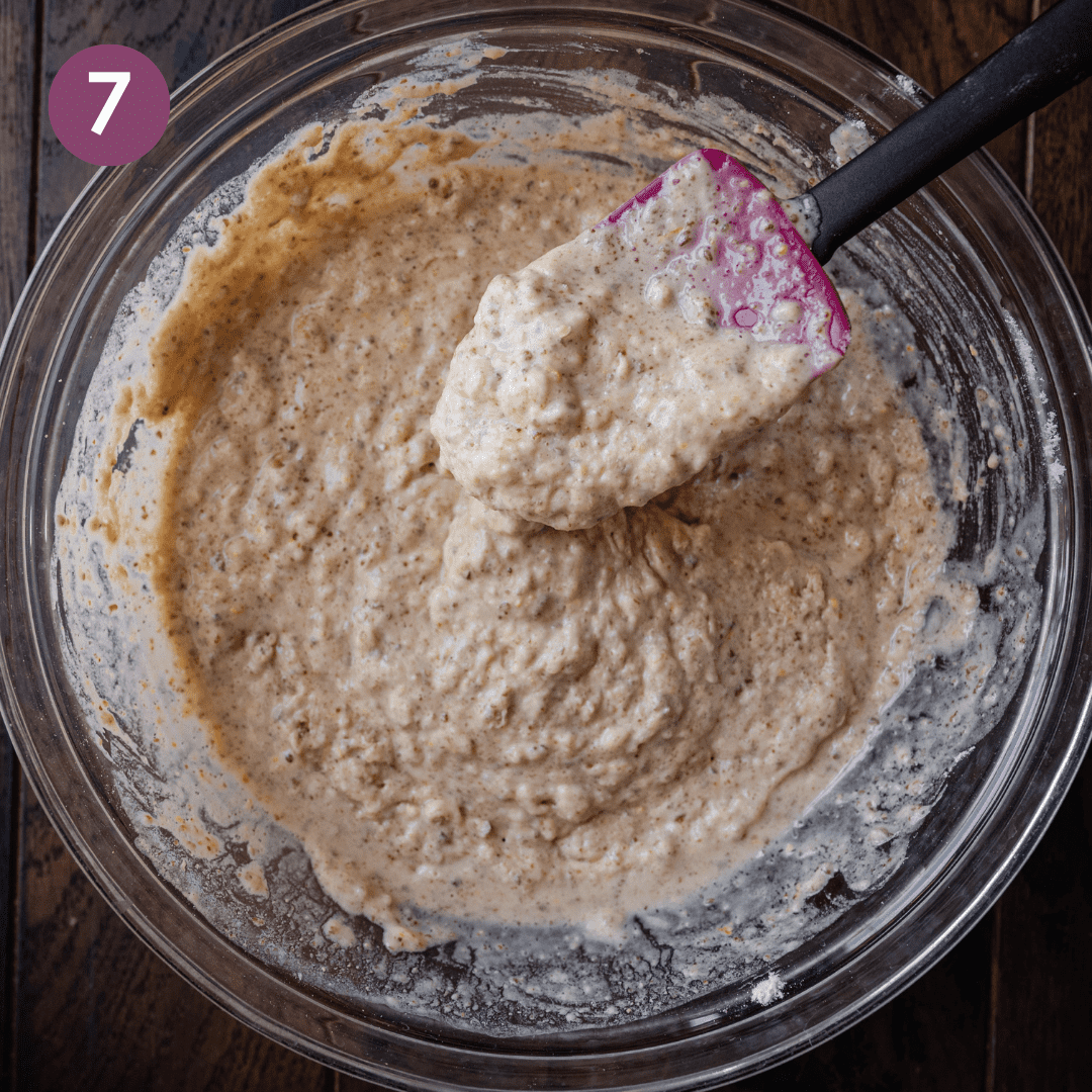 spatula showing thickness of muffin batter in glass bowl.