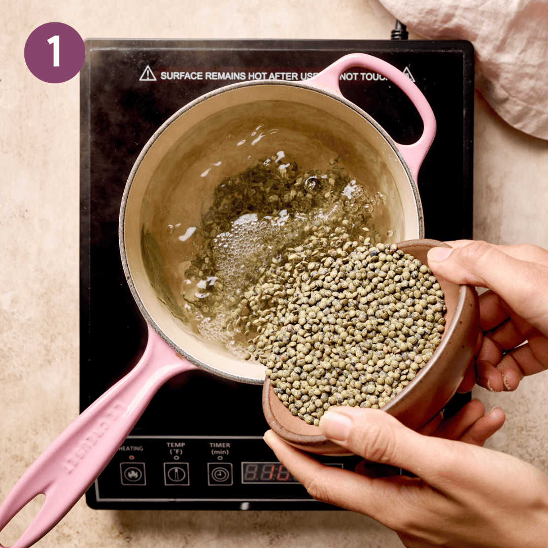 Person dumping uncooked lentils into a pot with water on a stove.