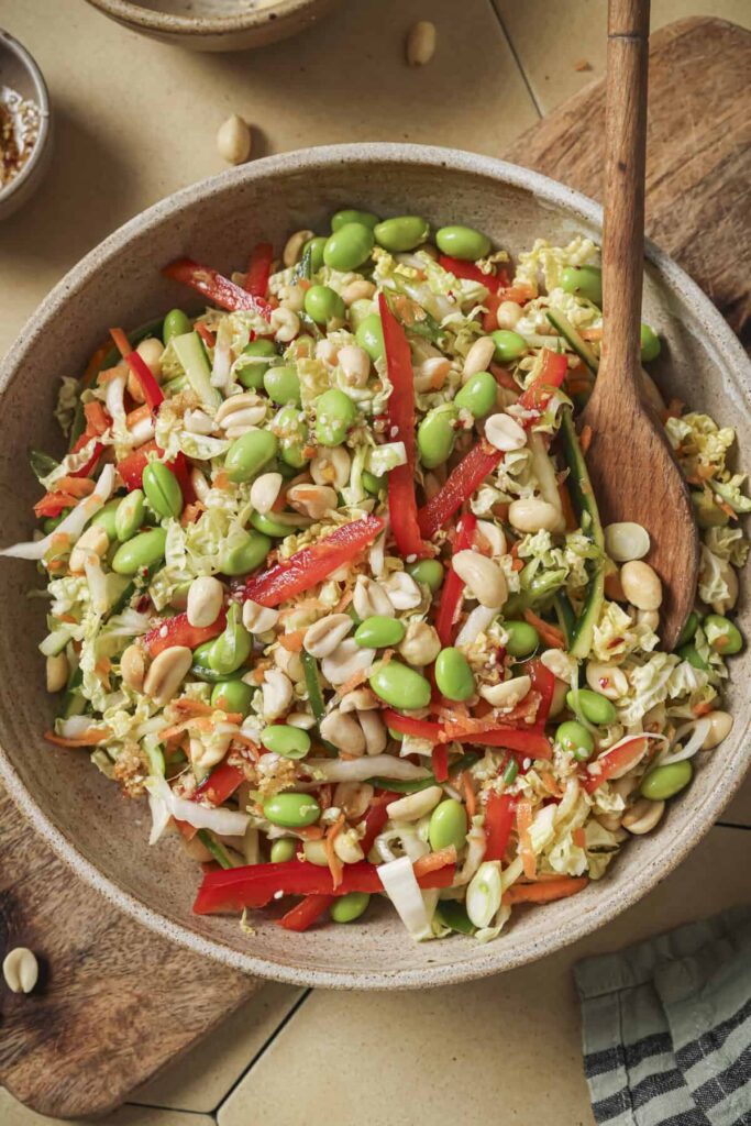 overhead view of salad with a wooden spoon.