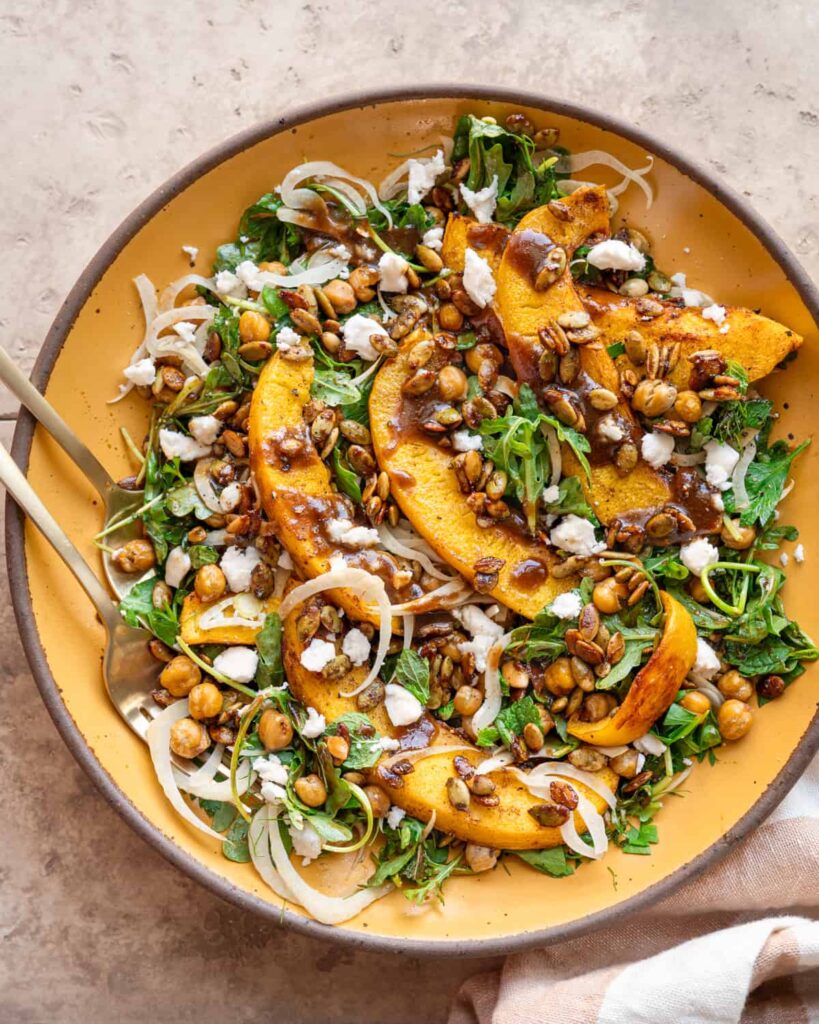 Pumpkin Salad on a large white serving platter on a table.